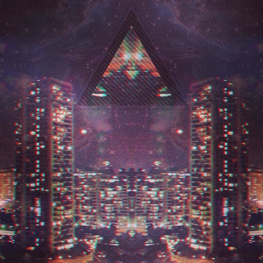 A tower at night arranged symmetrically with a giant hovering triangl in the sky.