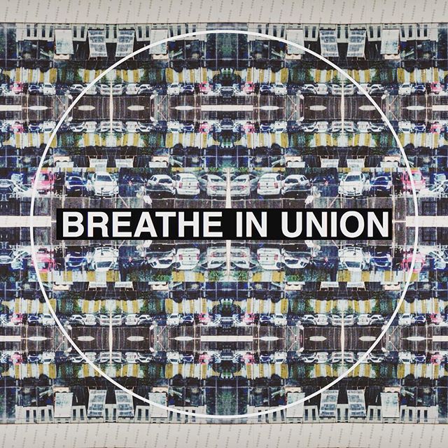 Cars in a packed parking lot with the text 'Breathe In Union' overlayed.